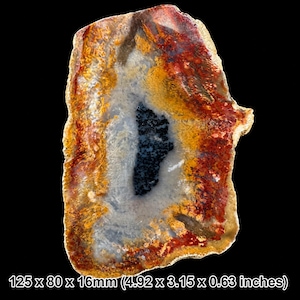May include: A polished agate slab featuring a central dark blue to black crystalline cavity surrounded by concentric bands of translucent white, vibrant orange, and deep red mineral deposits, measuring 125 x 80 x 16 mm.
