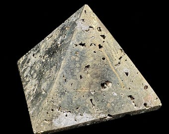 May include: A metallic, gold-toned pyrite pyramid with a textured, porous surface and sharp edges. The object measures 2.36 x 2.36 x 1.69 inches, as indicated by the text printed at the bottom of the image against a black background.