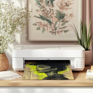 May include: A white printer with a black and white image of a woman with a cigarette in her mouth being printed. The image is on a yellow and white background.