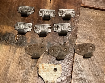 Antique iron ringer sash pulls.