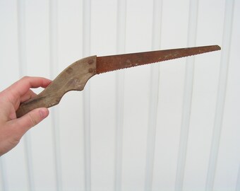 Antique saw wooden handle Rusty saw Primitive cutting tool Carpentry tool Sawing wood Working tool cutting wood Old hand saw for collection