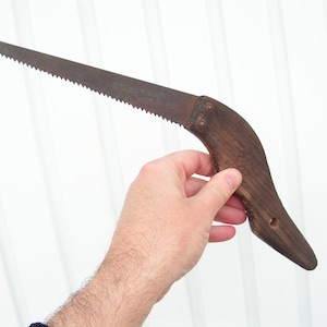 Vintage saw for wood Metal saw with wooden handle Carpentry tool Sawing wood Working tool cutting wood Old hand saw for collection