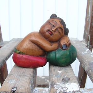 Wooden figure sleeping Buddha Religious art figurine Buddha colorful sculpture Far East religion Hand carved holy statue Wooden art figure