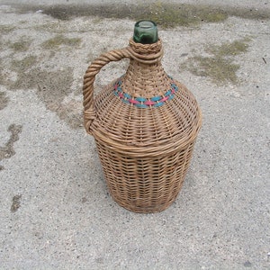 Vintage demijohn with threads Hand wicker whiskey bottle with colored plastic strips Big Hand-knitted wicker bottle Wrapped rustic bottle