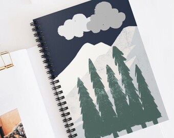 May include: A spiral bound notebook with a blue cover featuring a snowy mountain scene with white clouds and green trees.