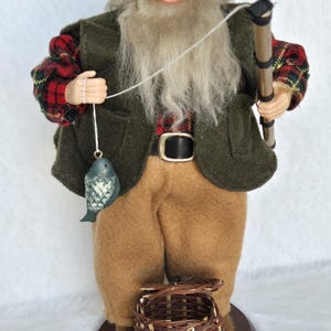 ceramic santa with fish and fishing pole Fishing Santa Claus Figurine