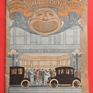 May include: Vintage advertisement for the Mason Opera House, featuring a detailed illustration. The artwork includes the opera house facade, vintage cars, and text with names and locations. The color palette is muted with shades of brown, blue, and orange.