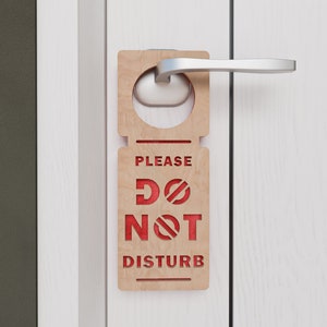 May include: A wooden door hanger with the text "PLEASE DO NOT DISTURB" in red lettering.