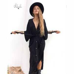 May include: A black button-down midi dress with a V-neckline, wide sleeves, and a matching tie belt at the waist. The garment features a front button closure and two side pockets. The text "Makemake.." with a heart symbol is visible in the top left corner.