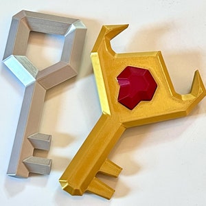 May include: Two keys, one silver and one gold, with a red gem on the gold key.