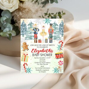 May include: A rectangular baby shower invitation card featuring a Nutcracker theme with watercolor illustrations of a mouse king, ballerina, nutcracker, gingerbread man, candy canes, and gifts. The text reads: JOIN US IN THE LAND OF SWEETS TO CELEBRATE Elizabeth's BABY SHOWER Sunday, December 3, 2024 12:00 pm Our Home 123456 Your Street Address City, State Zipcode RSVP You Contact Information Elizabeth is registered on Amazon.