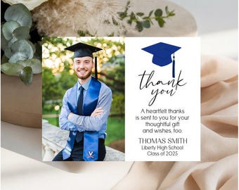 May include: A graduation thank you card featuring a photo of a graduate in a cap and gown with a blue stole. The card includes a blue graduation cap icon, the text "thank you", "A heartfelt thanks is sent to you for your thoughtful gift and wishes, too.", "THOMAS SMITH", "Liberty High School", and "Class of 2025".