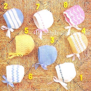 May include: Eight crocheted baby bonnets in various colors and patterns, including white, pink, blue, and yellow. The bonnets are numbered 1 through 8.