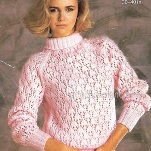 May include: A pink knitted sweater with a delicate lace pattern. The sweater has a high neck and long sleeves. The sweater is designed for a bust size of 30-40 inches or 76-102 centimeters.