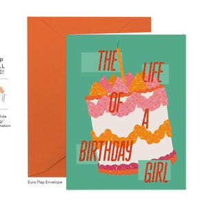 May include: A birthday card with a teal background and a large cake illustration. The cake is white with pink and orange frosting and a lit candle. Text on the card reads "The Life of a Birthday Girl."