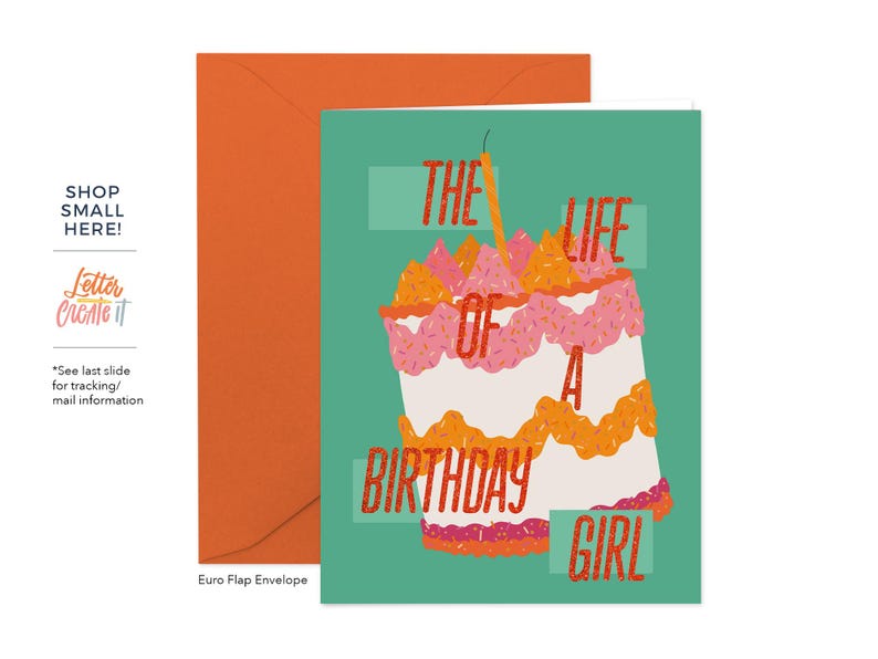 May include: A birthday card with a teal background and a large cake illustration. The cake is white with pink and orange frosting and a lit candle. Text on the card reads "The Life of a Birthday Girl."