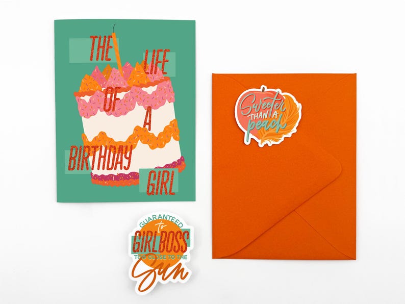 May include: A birthday card with a cake illustration and the text "The Life of a Birthday Girl." An orange envelope with a sticker that says "Sweeter than a peach." A sticker that says "Guaranteed to be the Girlboss to the Sun."