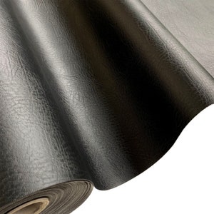 May include: A roll of black faux leather fabric with a textured surface.