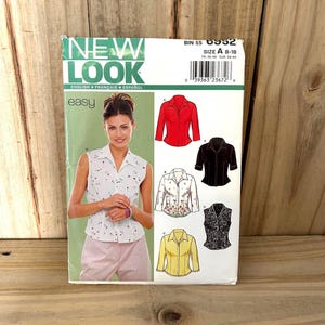 May include: A sewing pattern package from New Look features a woman wearing a white floral print top. The package includes illustrations of various blouse designs in red, black, white floral, and yellow. The text on the package reads "NEW LOOK" and "easy".