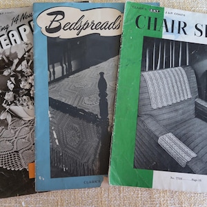 May include: Three vintage crochet pattern books with green, blue, and black covers. The covers feature images of crocheted pineapple, bedspread, and chair sets. The text on the covers reads "Featuring 14 New Pineapple", "Bedspreads", "Chair Sets", "Clark's Ont. Jap Coats", "No. 223", "No. 7288", "Page 11", and "10¢".