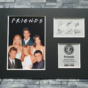 May include: A black framed photograph of the cast of the TV show "Friends" with their autographs. The photograph is a limited edition print numbered 005/100.