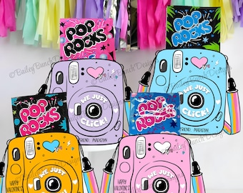 May include: Four colourful instant camera-shaped boxes with a Pop Rocks candy packet inside each. The boxes have a heart with a pink and white design, the words "We Just Click!" and "Your Friend, Madison".