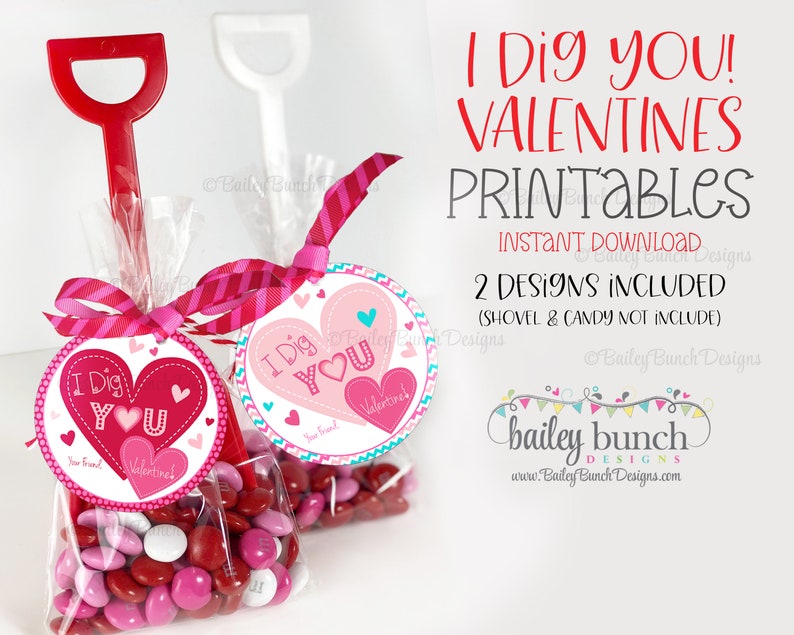 May include: Printable Valentine's Day gift tags featuring a red heart with the text "I Dig You!" and a pink heart with the text "Valentine's". The tags are attached to clear cellophane bags filled with red and pink candy hearts.