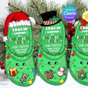 May include: Green Christmas-themed gift tags shaped like clogs, each with a different hat and festive decorations. Text reads "CROCIN' AROUND THE CHRISTMAS TREE!" and "MERRY CHRISTMAS". Includes a Santa hat, top hat, and star.