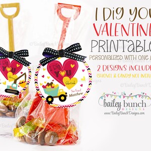 May include: Valentine's Day printable tags with the text "I Dig You!" featuring a heart and construction vehicle design. The tags are attached to toy shovels filled with candy, tied with a black and white polka dot bow.