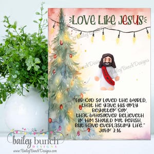 Puede incluir: Una impresión con temática navideña con el texto "Love Like Jesus". La imagen presenta un árbol de Navidad de acuarela con luces y adornos, y una pequeña figura de Jesús. La impresión también incluye un versículo bíblico.