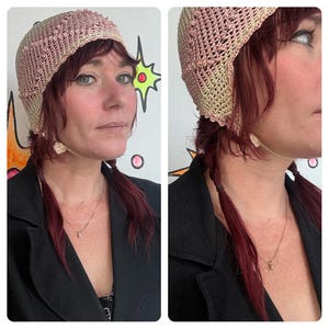 May include: A crocheted hat in shades of pink and beige. The hat has a delicate, open weave design with a scalloped edge. The hat is worn with a black jacket and a gold necklace.