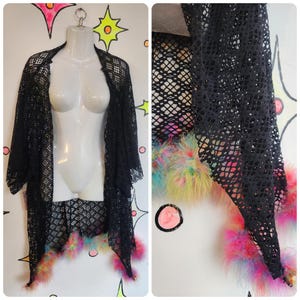 May include: Black mesh kimono with a colorful feather trim. The kimono is sheer and has a loose fit.