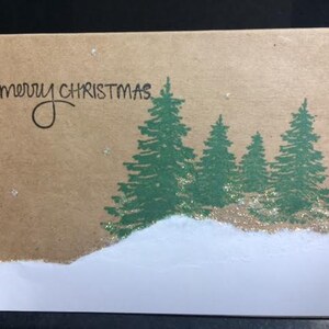 Carte de Noël maison d’arbres et de neige