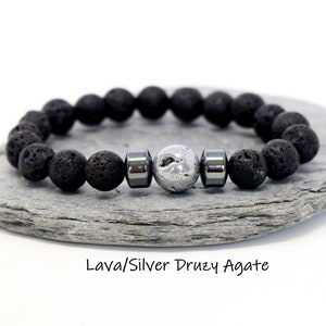 Op de afbeelding: Zwarte lavastenen en zilveren druzy agaat kralen armband met twee zilveren hematiet kralen.