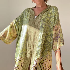 May include: A green and yellow patterned shirt with a floral design. The shirt has a collar and a button-up front. The shirt is made of a lightweight fabric and has a relaxed fit.