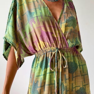 May include: A handmade, ceramic mug with a speckled, cream-colored glaze. The mug features a wide, rounded body and a sturdy handle. The interior is a darker, contrasting shade. Perfect for coffee or tea.