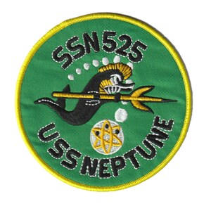 May include: A green and yellow embroidered patch with the text "USS NEPTUNE SSN 525". The patch features a black seahorse with a gold trident and a white atom symbol.