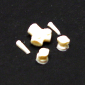 May include: A set of five white plastic model pieces for a model kit. The pieces include a cross-shaped piece, two small round pieces, and two long, thin pieces.