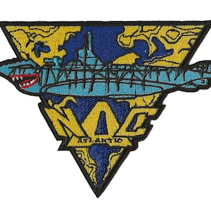 Könnte beinhalten: Ein gestickter Aufnäher in Gelb und Blau mit einem U-Boot und dem Text "NAC ATL-ANT-IC".