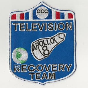 May include: Blue and white embroidered patch with the text "TELEVISION RECOVERY TEAM" and "APOLLO 8" with a globe and the ABC logo.