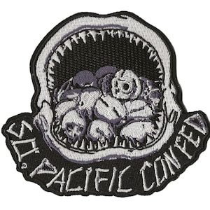 May include: A black and white embroidered patch featuring a shark's open mouth, revealing a pile of skulls inside. The text "SO. PACIFIC CONVOY" is written around the shark's mouth.