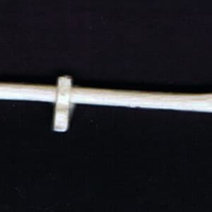 May include: A white metal miniature axe with a wooden handle. The axe head has a sharp blade and a rounded hammer head.