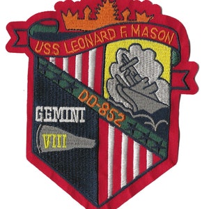 May include: A red, white, and blue embroidered patch with the text "USS LEONARD F. MASON DD-852 GEMINI VIII". The patch features a ship sailing on a yellow background with a gray cloud above it.