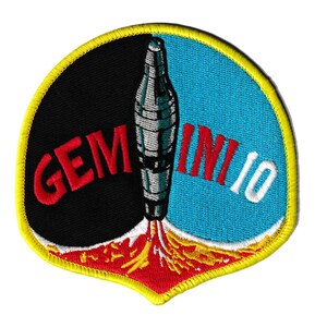 May include: Embroidered patch featuring a rocket launching from a red and yellow flame. The patch is divided into black and blue sections, with the words "GEMINI 10" in red and white. The patch has a yellow border.
