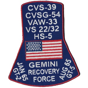 May include: A blue and red embroidered patch with the text "CVS-39, CVSG-54, VAW-33, VS 22/32, HS-5, JAN 65 GT-2, GEMINI RECOVERY FORCE, AUG 65 GT-5" and a small American flag in the center.