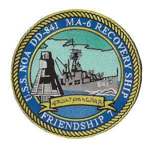 May include: A blue and yellow embroidered patch with a ship and a space capsule. The text on the patch reads "U.S.S. NOA DD-841 MA-6 RECOVERY SHIP" and "ASTRONAUT JOHN H. GLENN, JR. FRIENDSHIP 7".