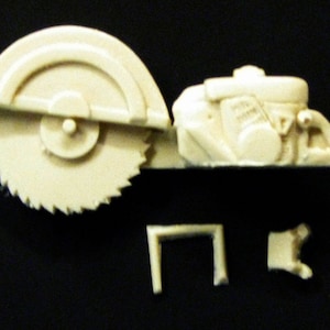 May include: A white plastic model kit of a circular saw with a blade, motor, and handle. The kit includes four separate pieces.