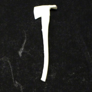 May include: A white plastic toy axe with a wooden handle. The axe is approximately 25 cm long.