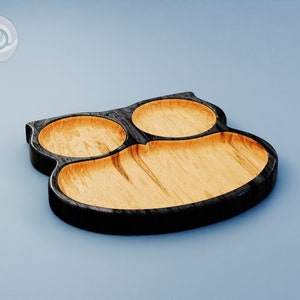 May include: A wooden serving tray with three separate compartments, shaped like an owl. The tray is black with a natural wood finish inside the compartments.