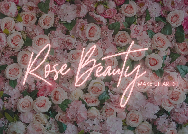 May include: A pink neon sign with the text "Rose Beauty MAKE-UP ARTIST" against a background of pink and white roses.